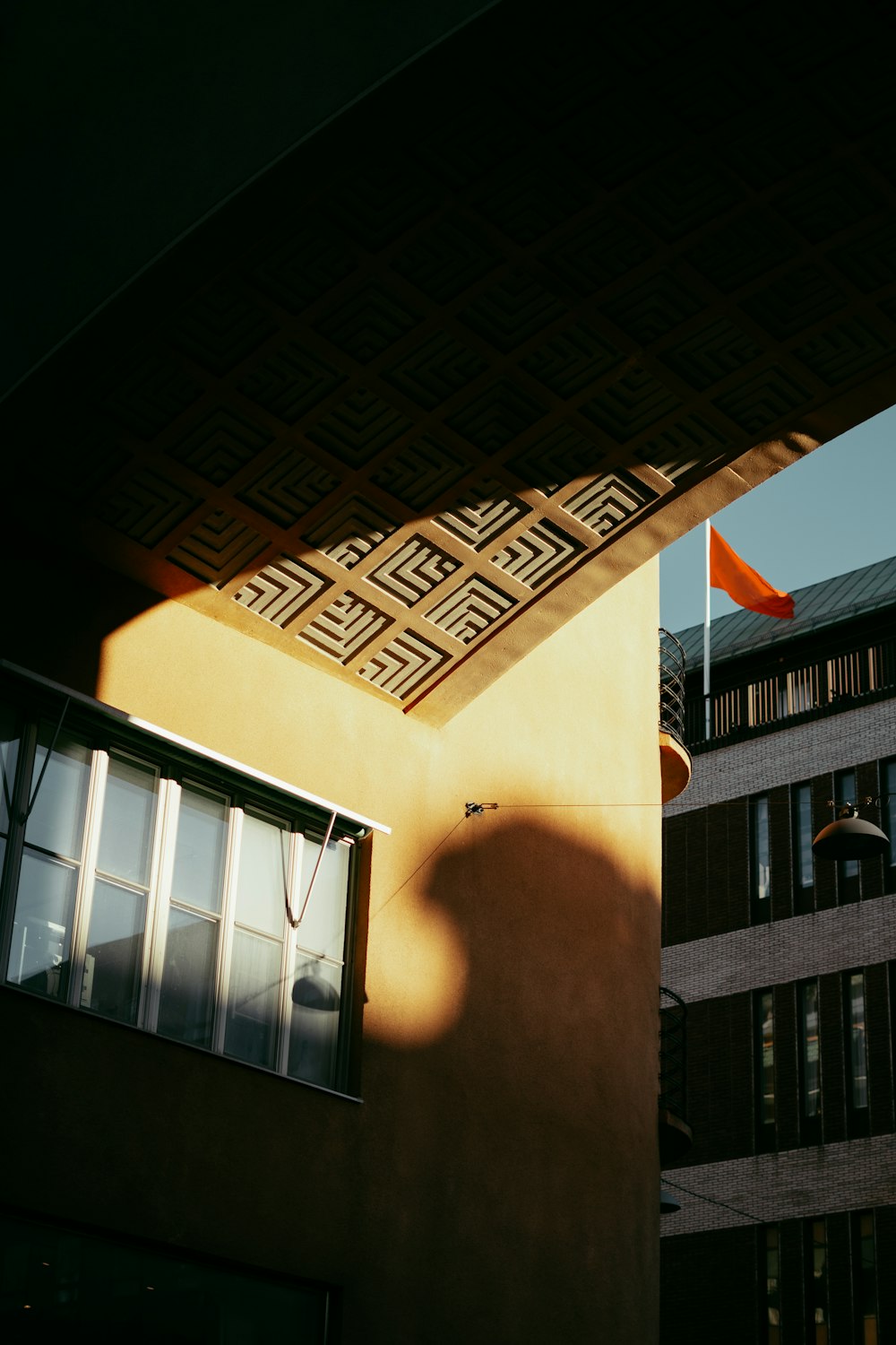 the shadow of a building on the side of a building