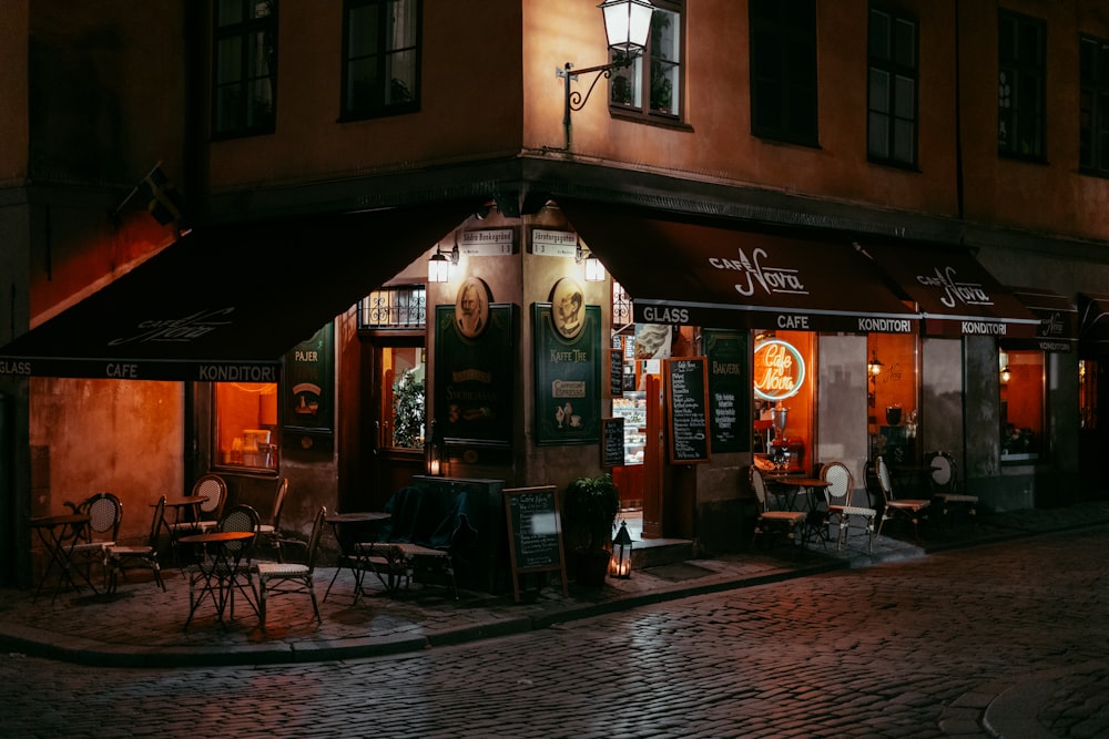 a street corner at night with a restaurant lit up