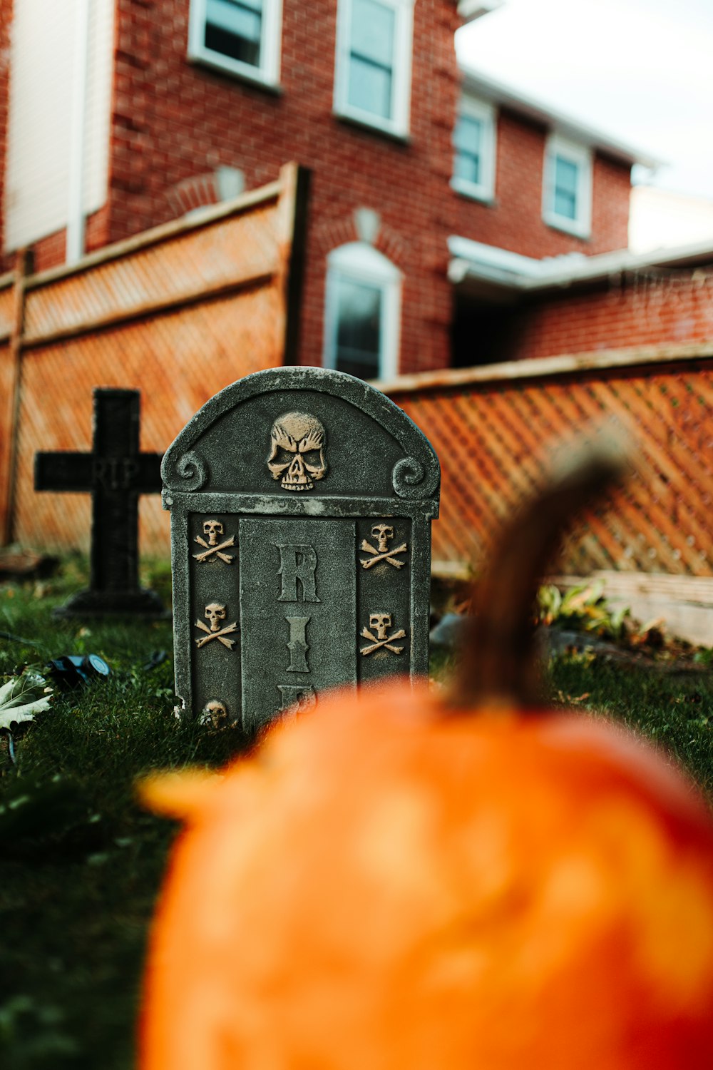 a grave with a pumpkin in the foreground