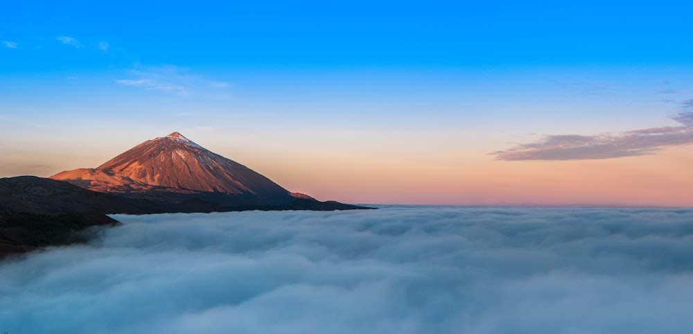 a view of a mountain covered in clouds