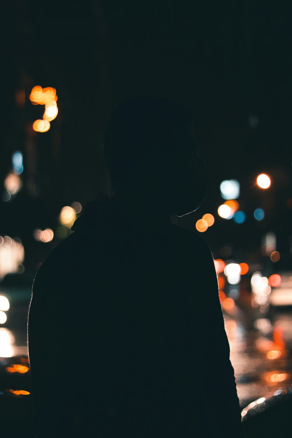 a person standing on a street at night