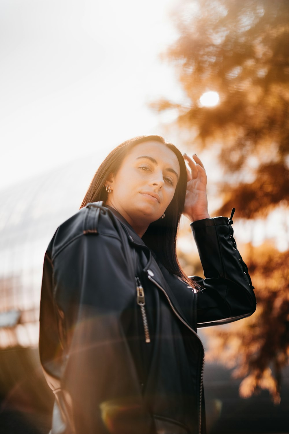 a woman with long hair wearing a black jacket