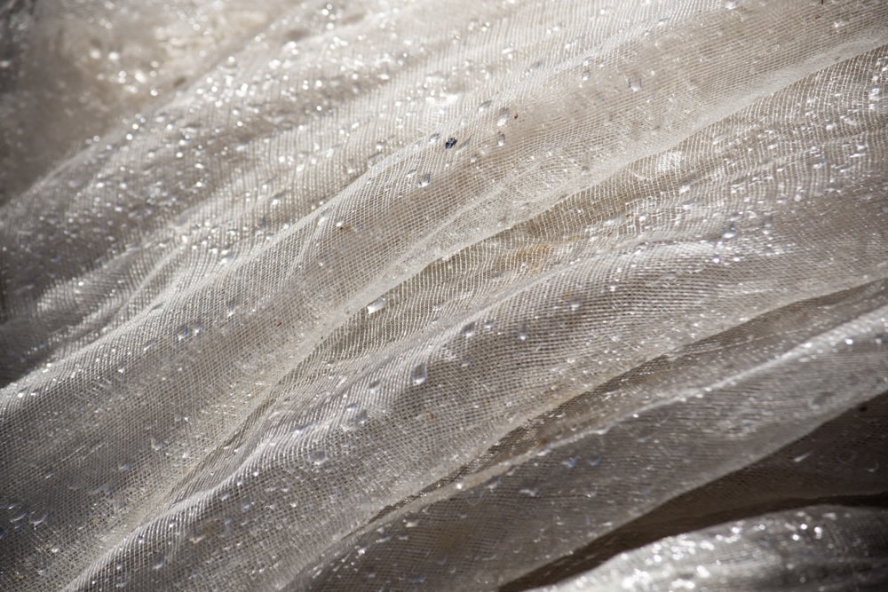 a close up of a fabric with water droplets on it