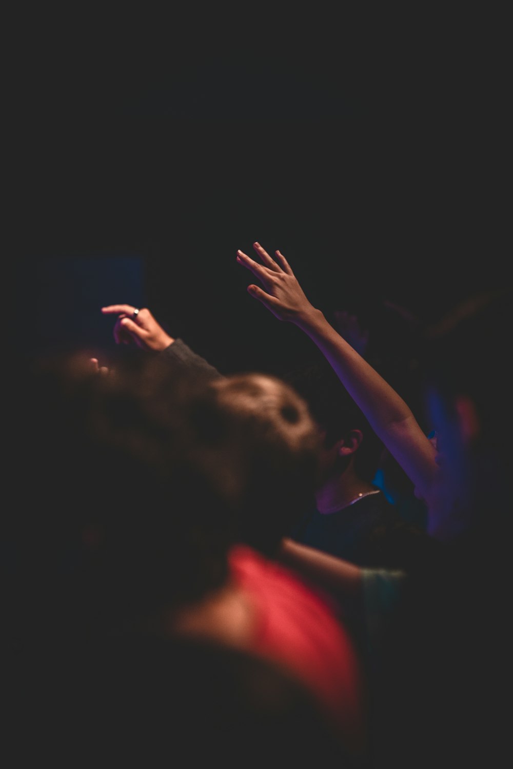 a group of people reaching up in the air