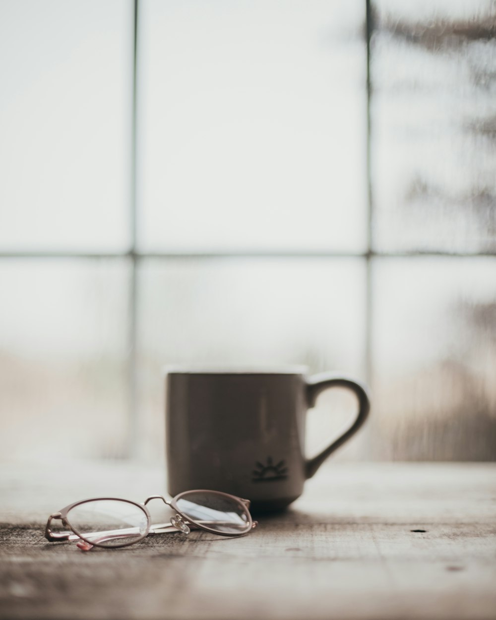 a pair of glasses sitting on top of a wooden table