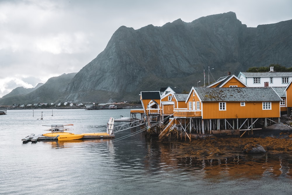 a group of houses sitting on top of a body of water