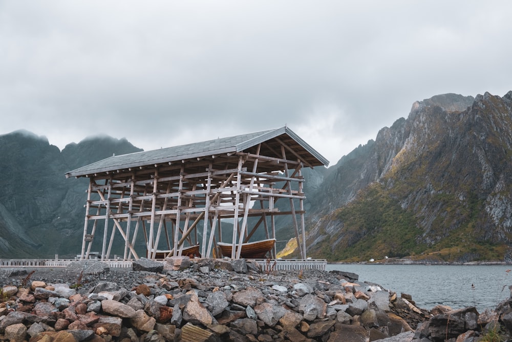 a wooden structure sitting on top of a pile of rocks