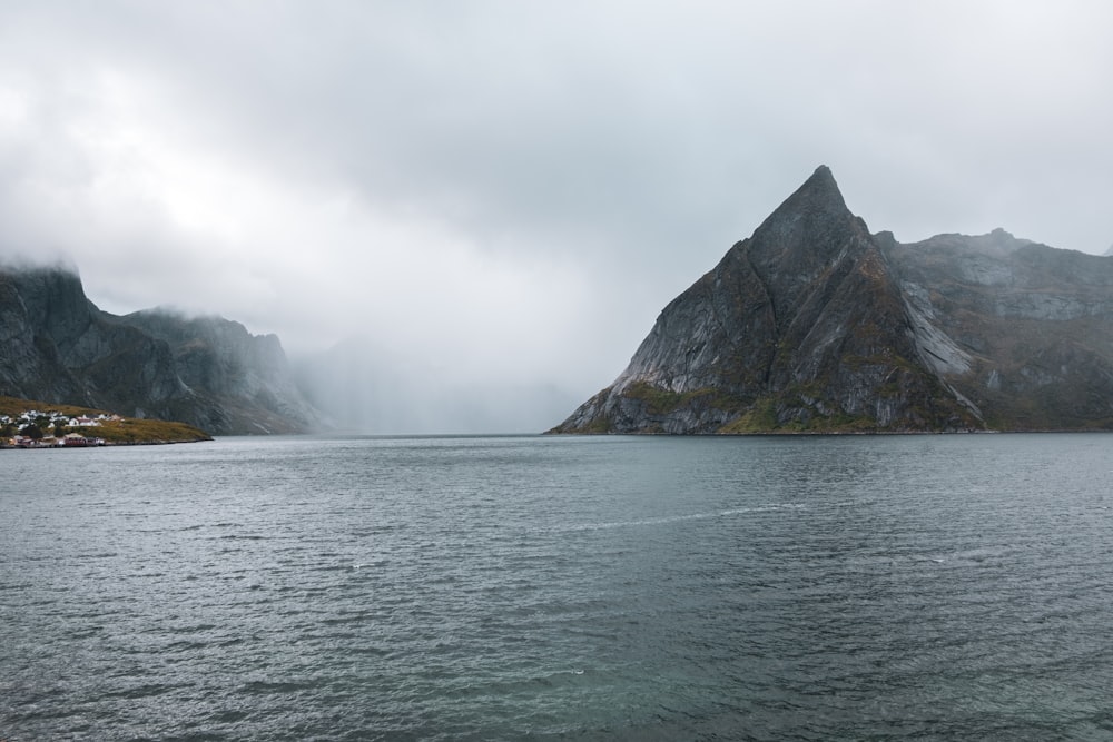 a body of water with mountains in the background