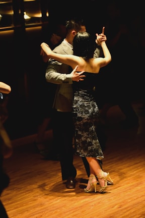 A couple elegantly dancing tango at a local event.