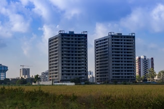 a couple of tall buildings sitting next to each other