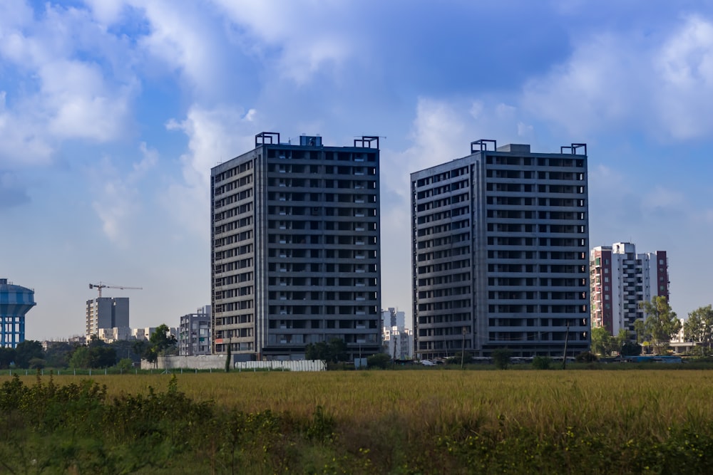 a couple of tall buildings sitting next to each other