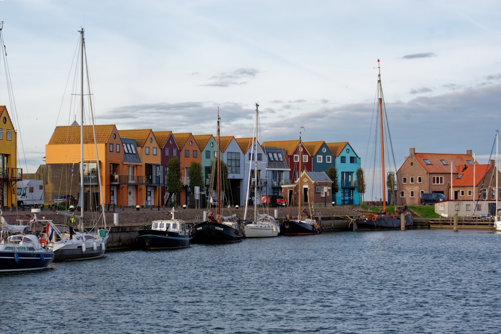 a harbor filled with lots of boats next to tall buildings