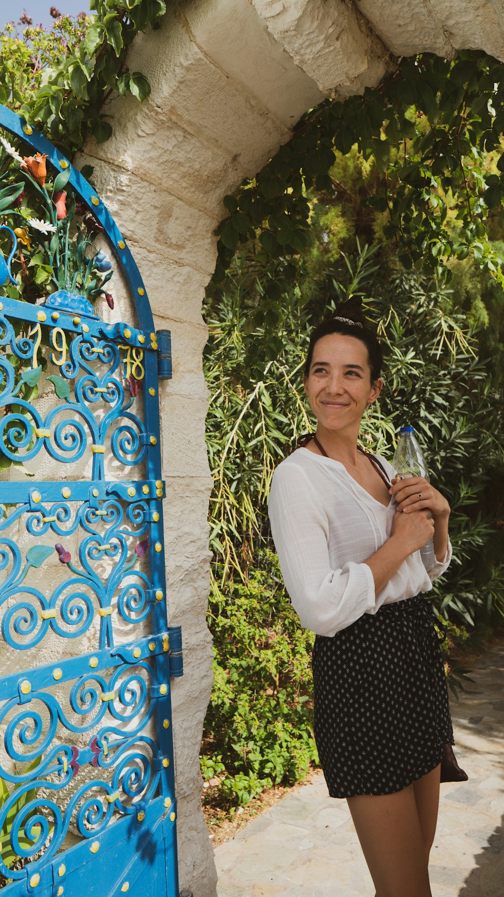 a woman standing in front of a blue door