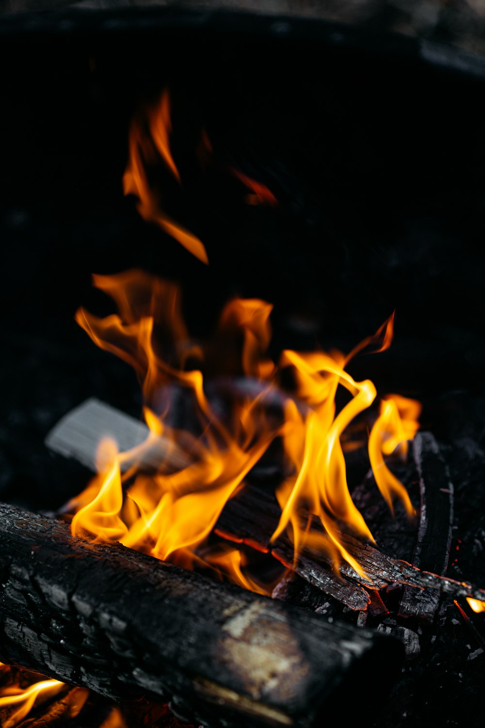 a close up of a grill with flames