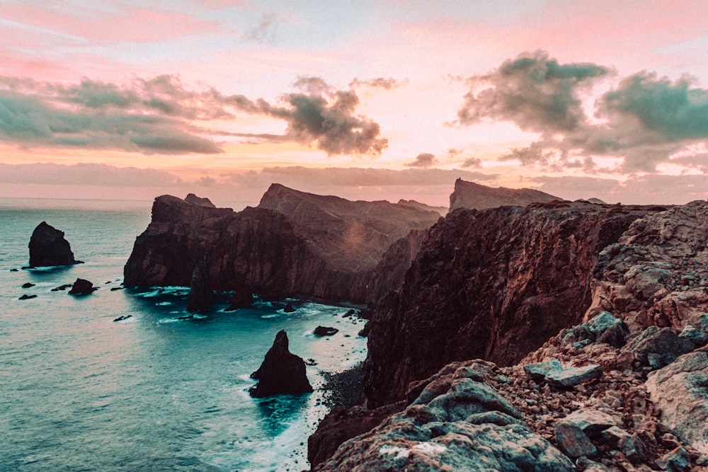 a view of the ocean from a rocky cliff