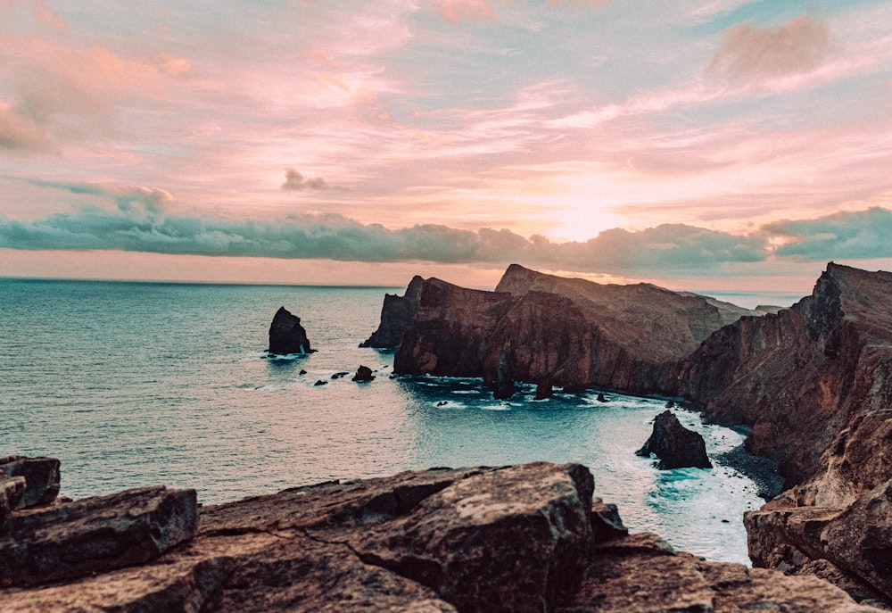 a view of the ocean from a rocky cliff