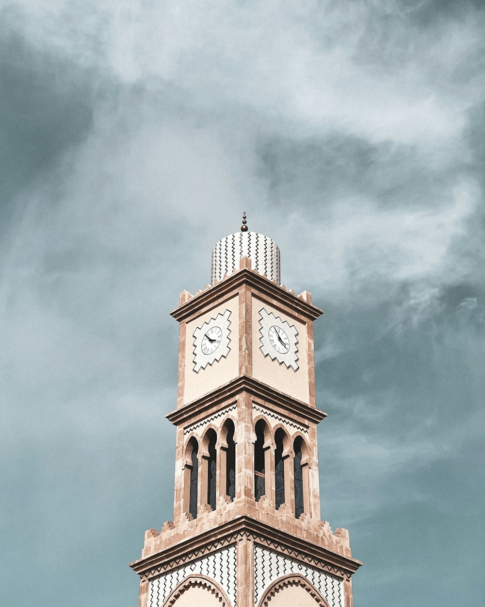 a clock tower with a cloudy sky in the background