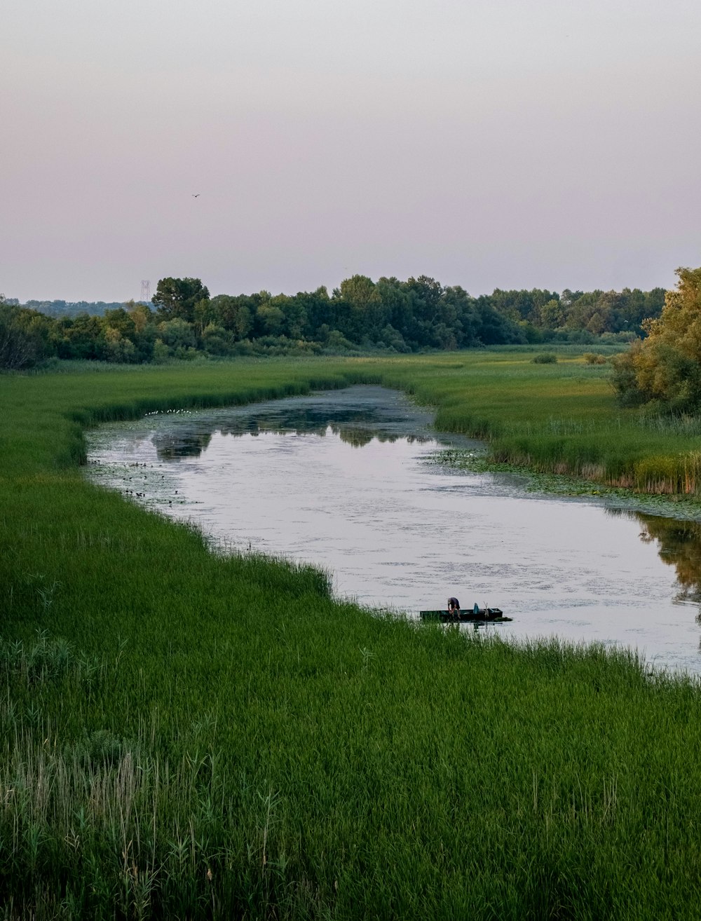 a man in a small boat on a river