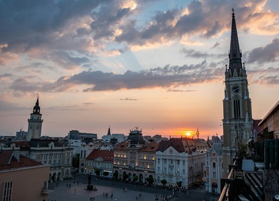 The cathedral spire over the roofs at sunset — Novi Sad, Serbia