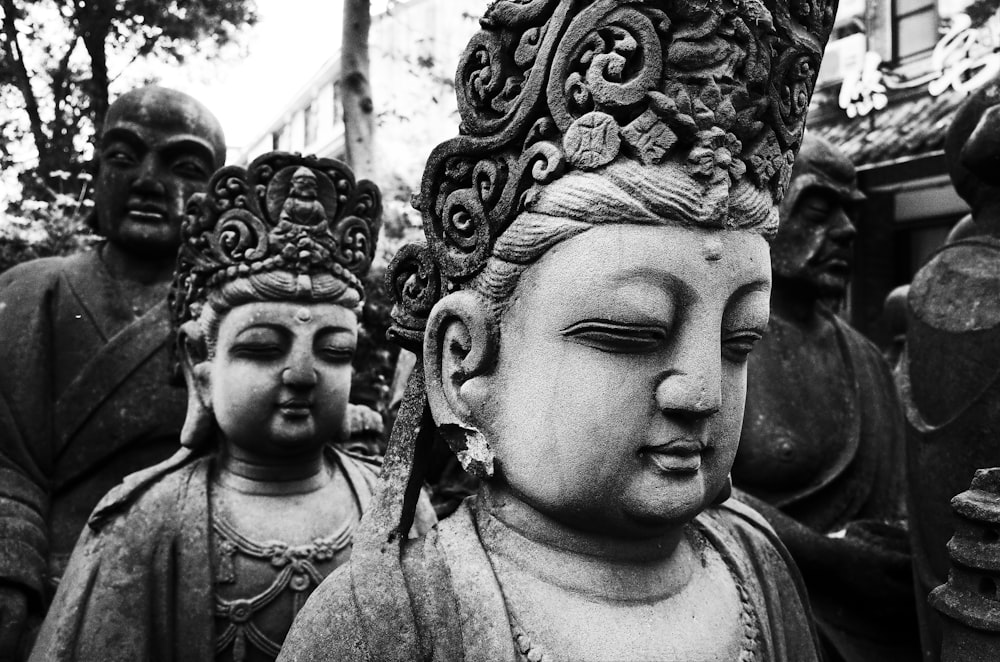 a black and white photo of buddha statues