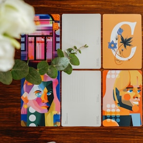 four notebooks sitting on top of a wooden table