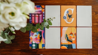 four notebooks sitting on top of a wooden table