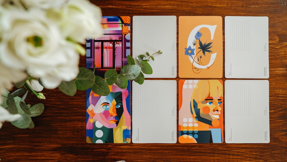 four notebooks sitting on top of a wooden table