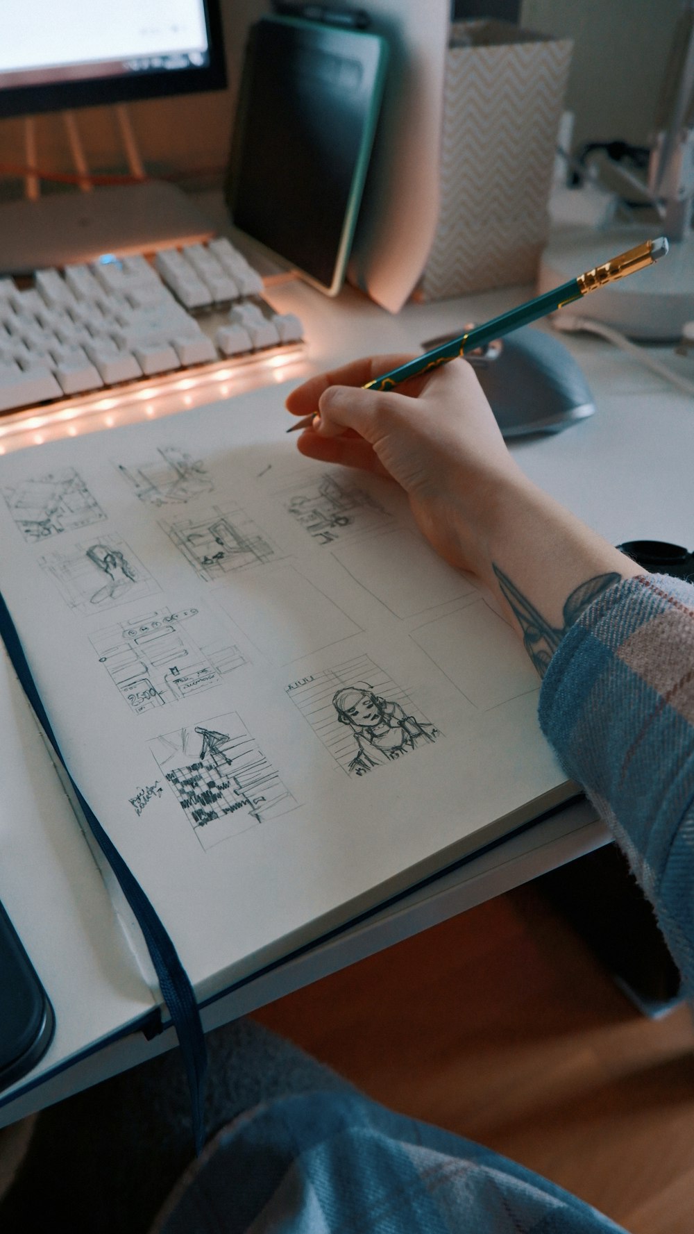 a person sitting at a desk with a pen in their hand