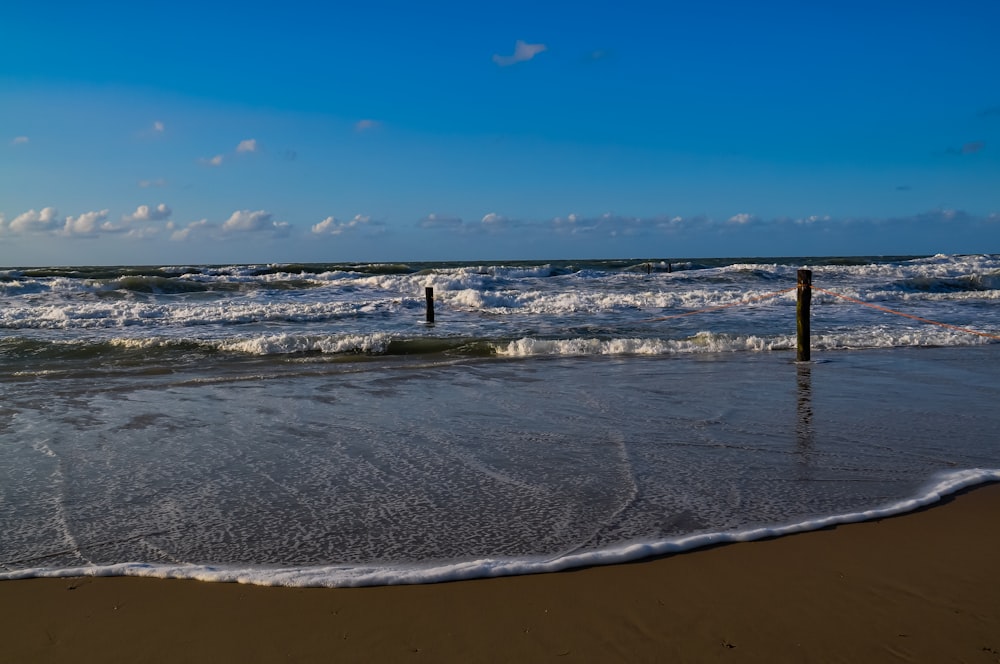 a beach with waves coming in and out of the water