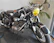 A shiny black vintage motorcycle displayed against a white background.