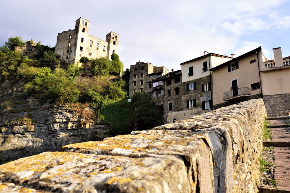 a stone wall with buildings on top of it