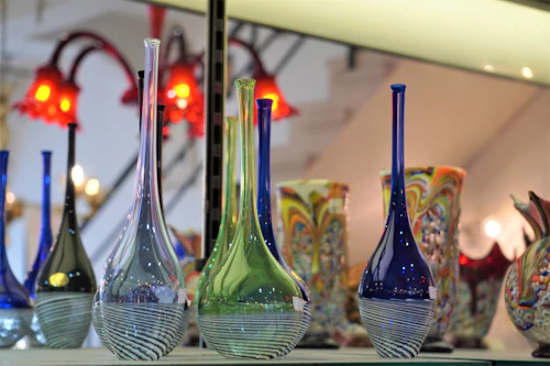 Finished glass vessels resting on a shelf