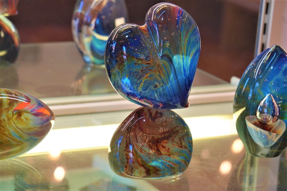 a group of glass vases sitting on top of a table