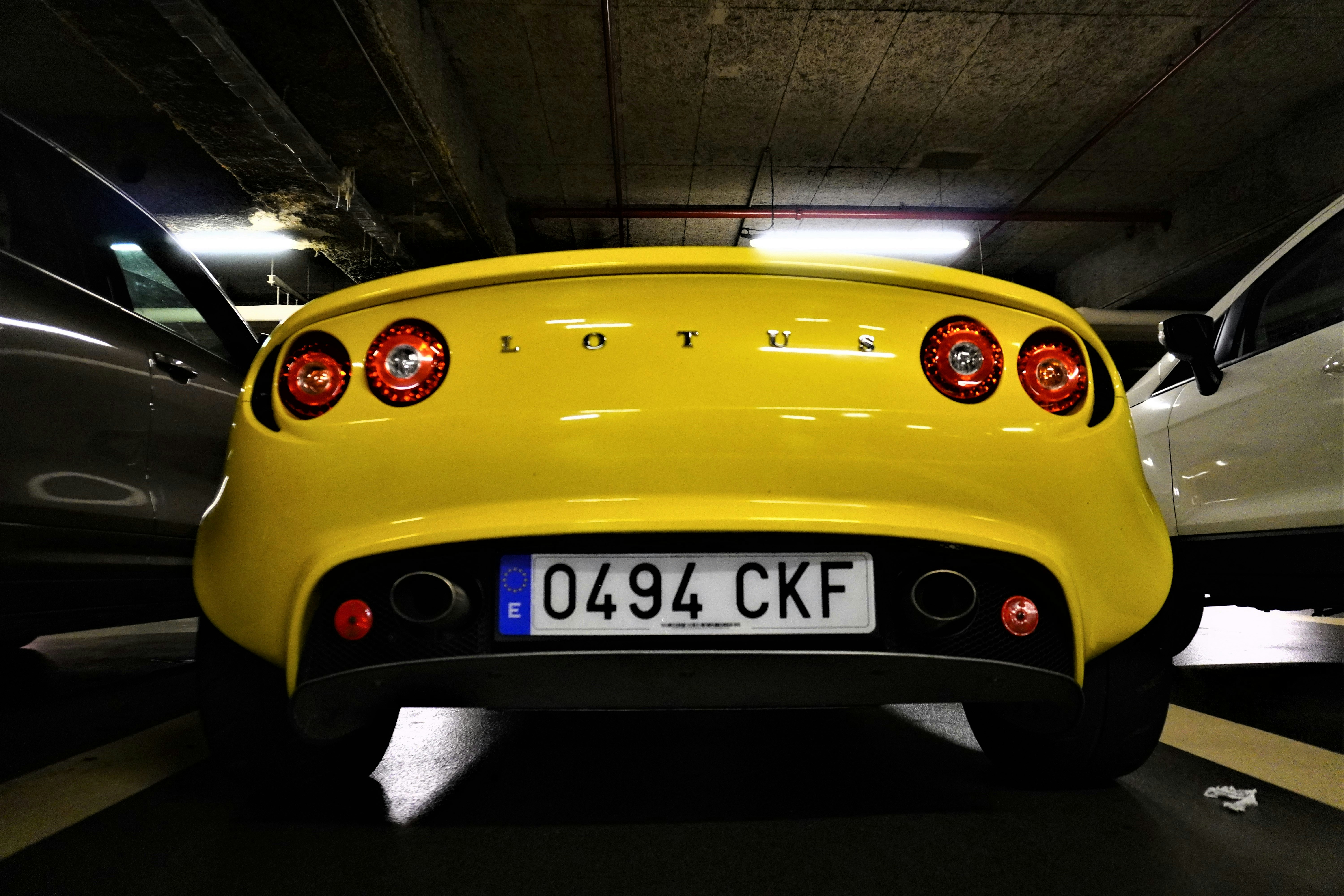 a yellow sports car in a parking garage