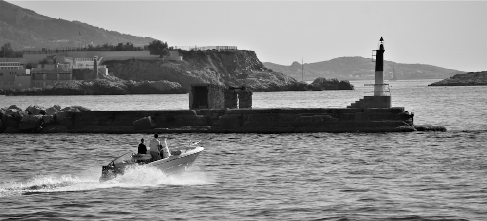 a man riding a boat across a body of water