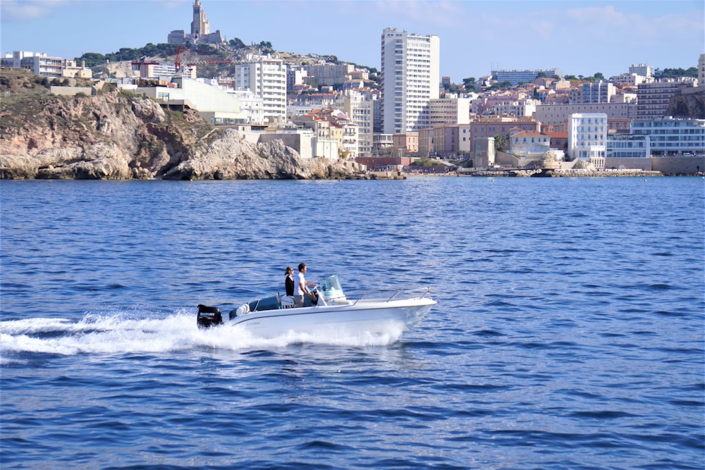 two people on a small boat in the water