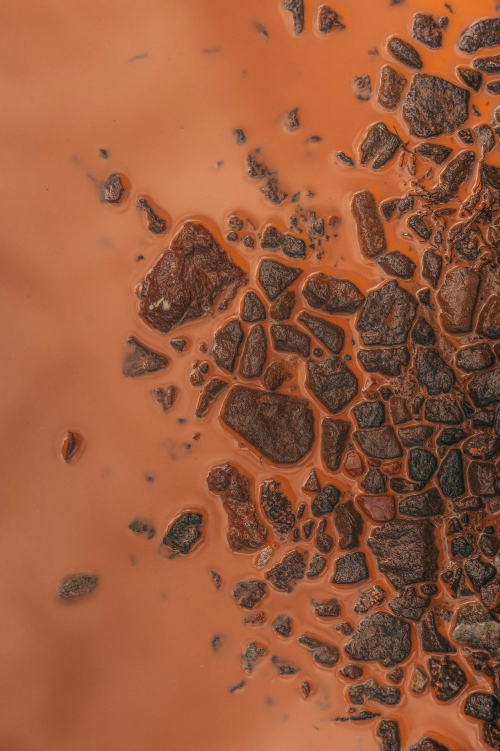 a close up of rocks and water in a puddle