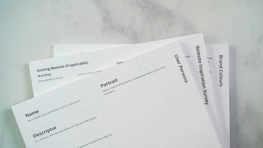 a close up of three papers on a table