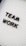 Black plastic letters forming the words 'TEAM WORK' are placed on a white letter board with horizontal grooves.
