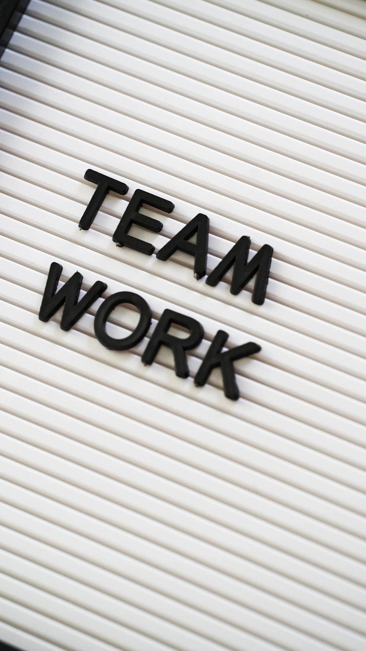 A sign that says team work on it