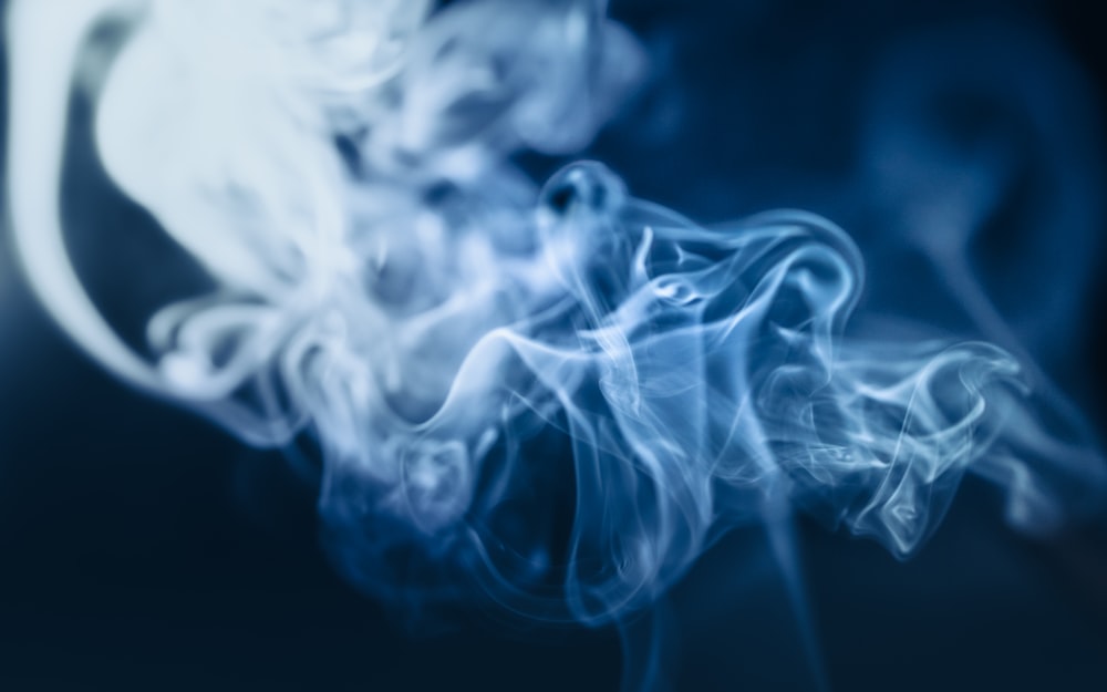 a blue and white smoke texture on a black background