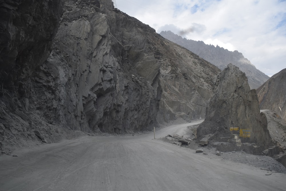 a car driving down a mountain road in the mountains