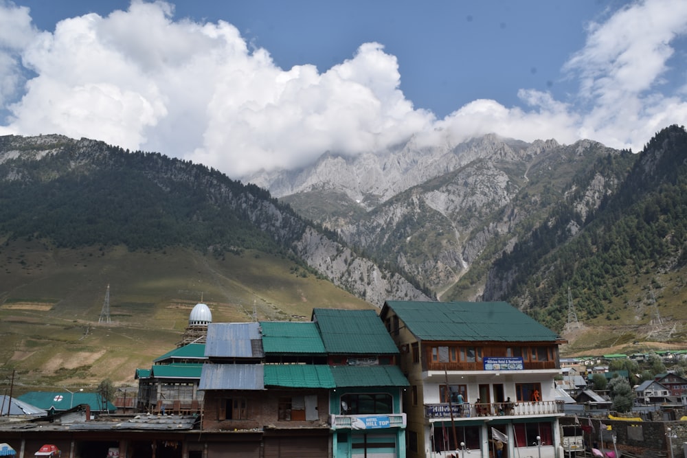 a group of buildings in front of a mountain range