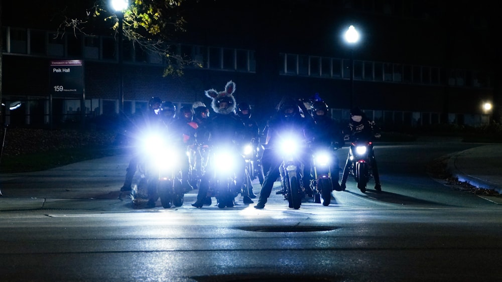 a group of police officers on motorcycles at night