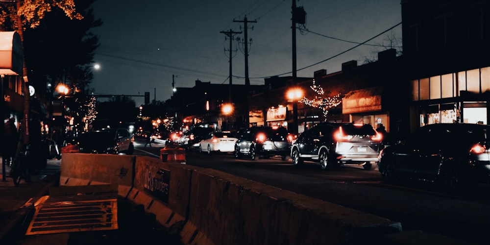 a city street filled with lots of traffic at night