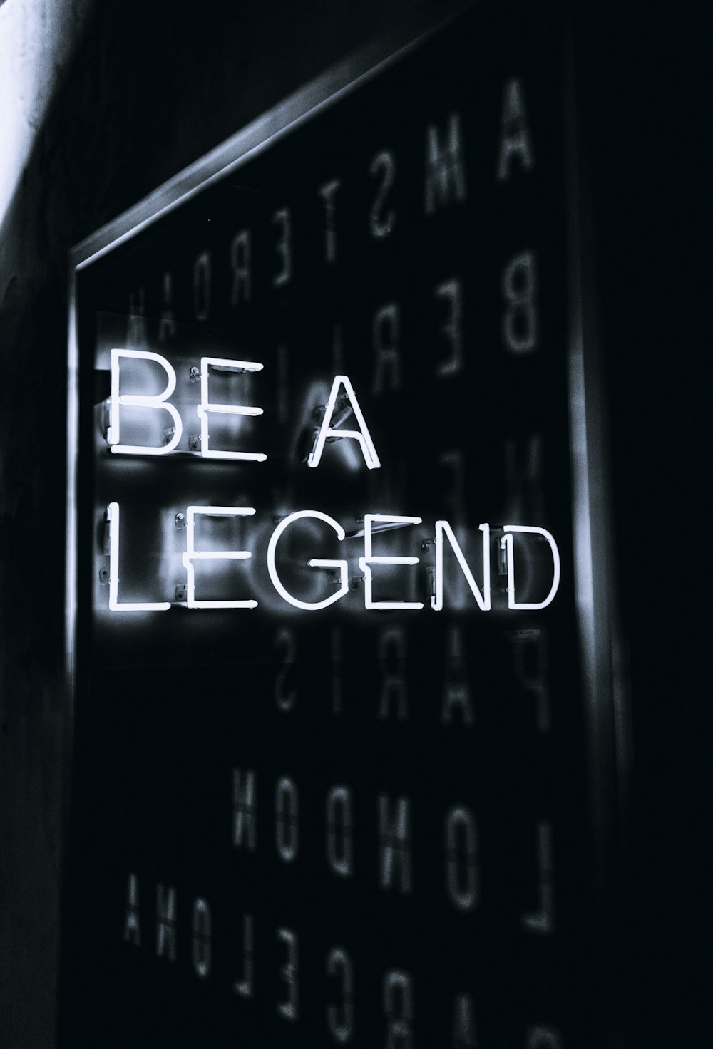 a black and white photo of a sign that says be a legend