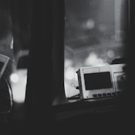 Monochrome image of a defibrillator device ready for emergency use.