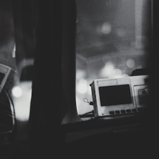 Monochrome image of a defibrillator device ready for emergency use.
