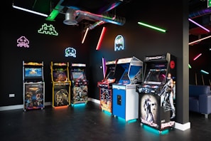 a room filled with arcade machines and neon lights