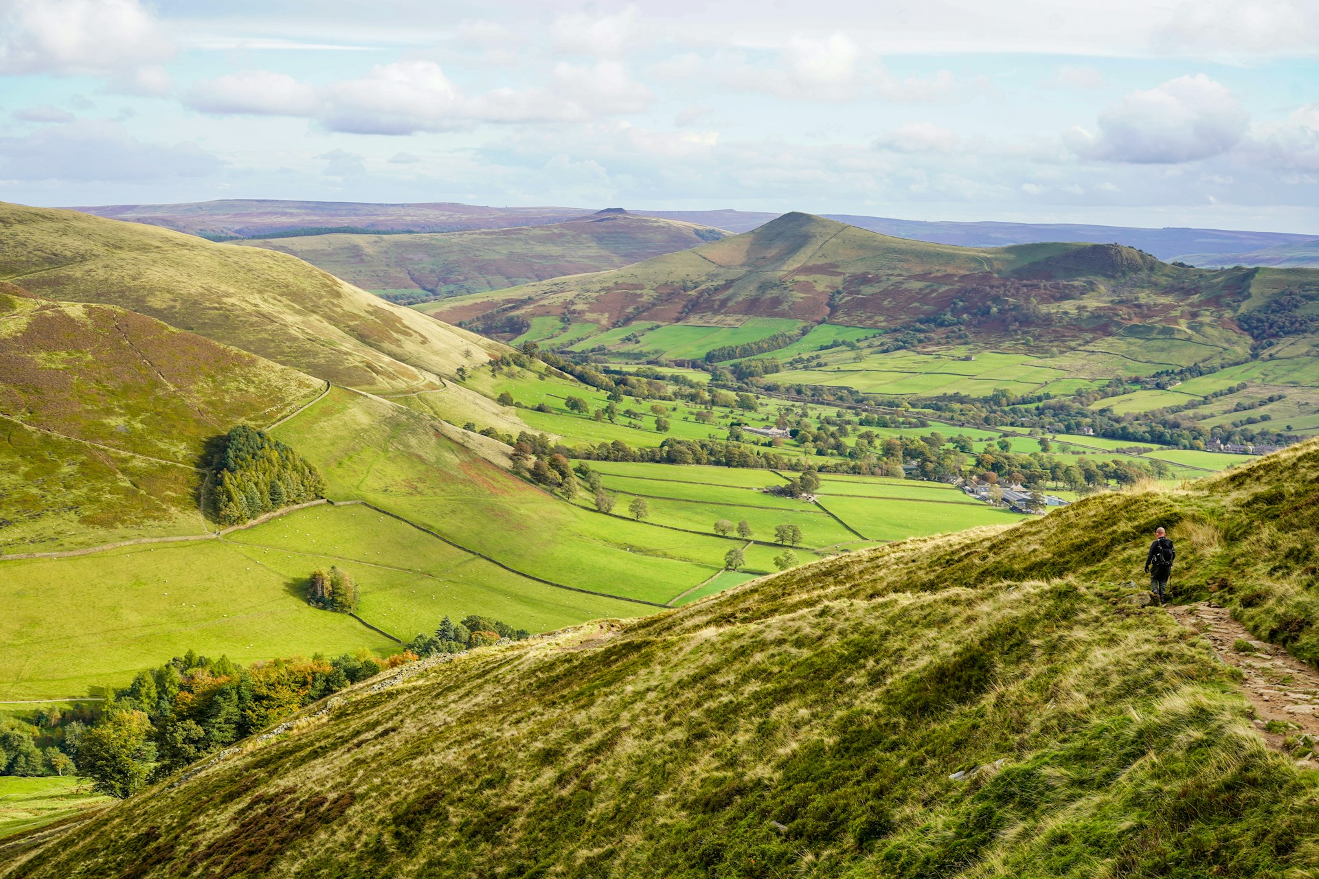 a person standing on top of a lush green hillside
